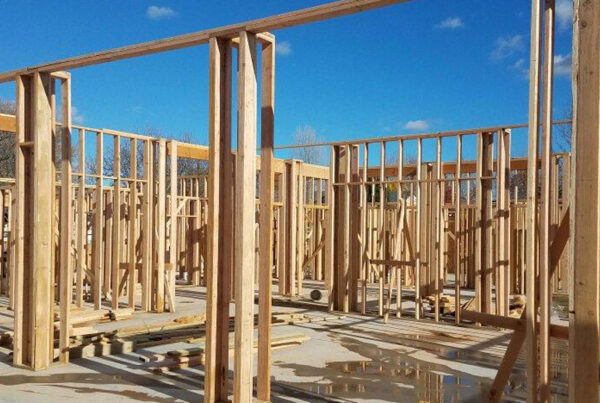 A large concrete pad with walls framed in.