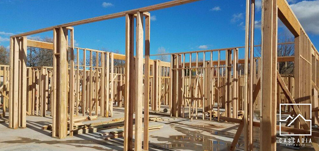 A large concrete pad with walls framed in.